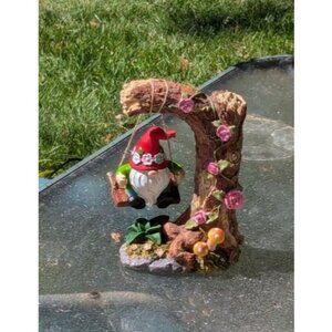 Solar Garden Statue Decor: Gnome Sitting on a Swinging Under Tree Stump